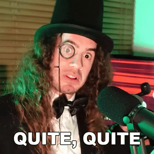 a man with long hair wearing a top hat and bow tie says quite quite