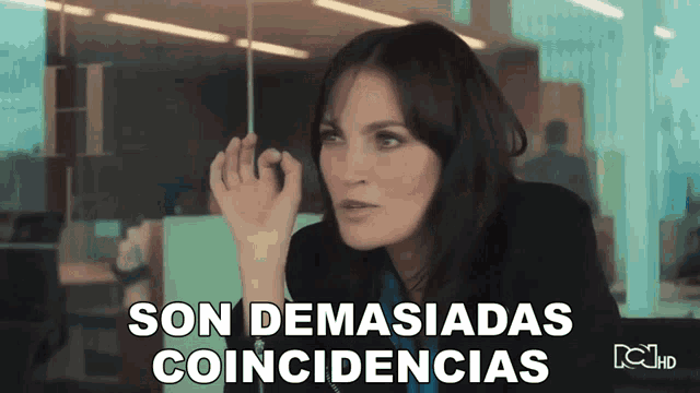 a woman sitting in front of a window with the words son demasiadas coincidencias on the bottom