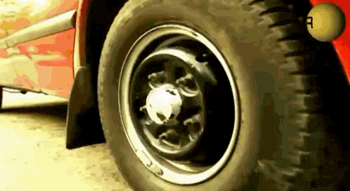 a close up of a tire on a red car with the letter a on it