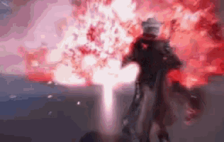 a person is standing in front of a huge explosion in a video game .