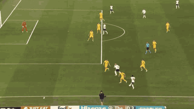 a soccer game is being played on a field with a sign that says ' united airlines ' on it