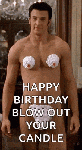 a shirtless man with whipped cream on his chest is standing in front of a sign that says `` happy birthday blow out your candle ''