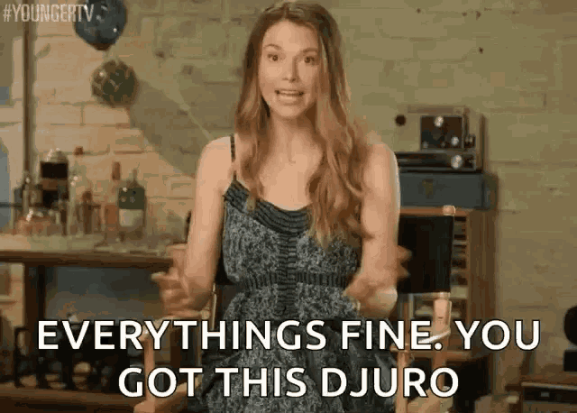 a woman in a blue dress is standing in a room and saying `` everything 's fine , you got this djuro ''