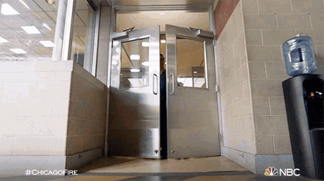 a nbc advertisement for chicago fire shows a person walking through a doorway