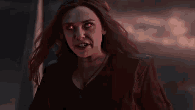 a close up of a woman with red eyes and a black jacket .