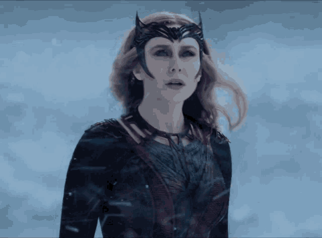 a close up of a woman wearing a mask and a costume