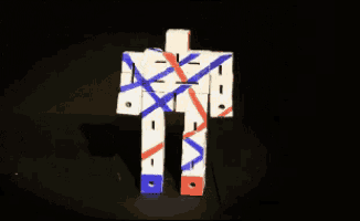 a robot made out of red white and blue blocks on a black background