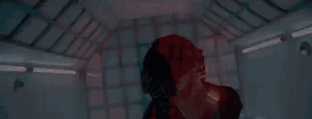 a man with dreadlocks and a tattoo on his hand is covering his face .