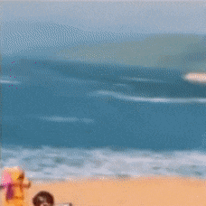 a blurred image of a person on a beach with a book