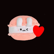 a macaron with bunny ears and a red heart on a black background