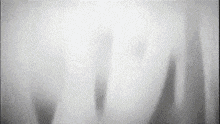 a black and white image of a person 's shadow on a wall