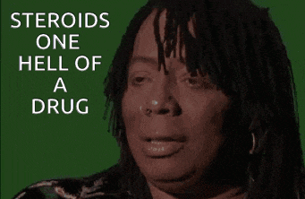 a woman with dreadlocks is smiling in front of a green background that says " steroids one hell of a drug "