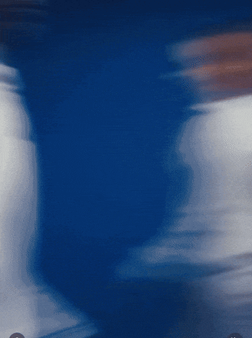 a blurry picture of a person 's torso in a blue background