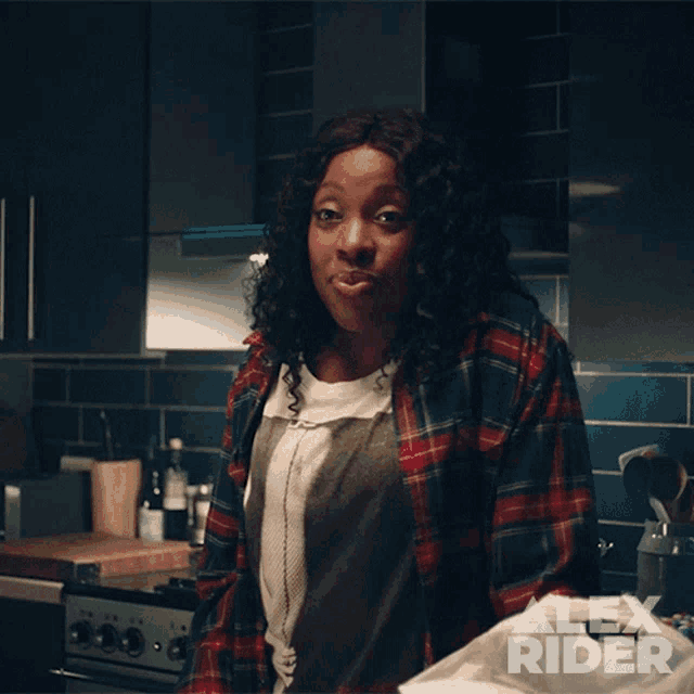 a woman in a kitchen with alex rider written on the corner