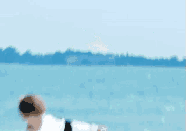 a man holding a blue umbrella on a beach