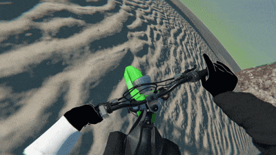 a person riding a bike on a sandy road