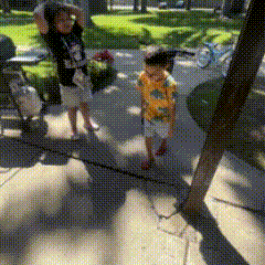 a blurred image of two children walking in a park