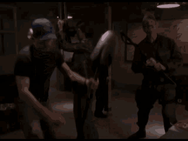 a man in a blue hat is holding a shovel in a dark room