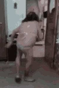 a woman in a bikini is dancing in a room