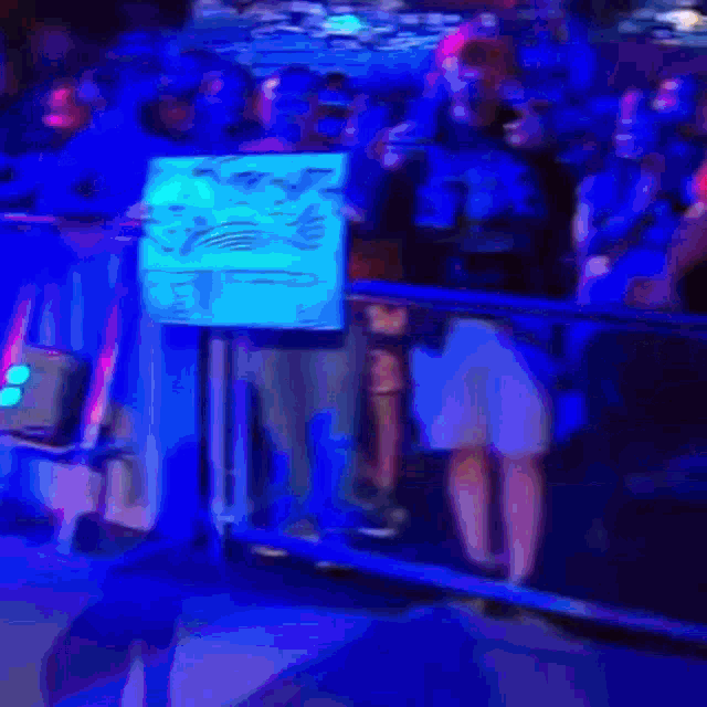 a group of people standing behind a fence with a sign that says ' i love you '