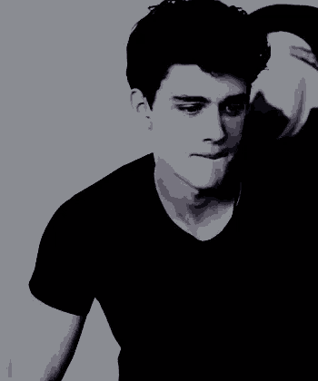 a black and white photo of a young man in a black shirt