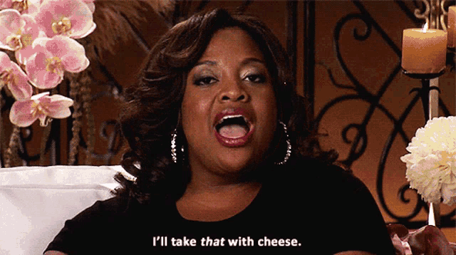 a woman sitting on a couch with her mouth open and says i 'll take that with cheese