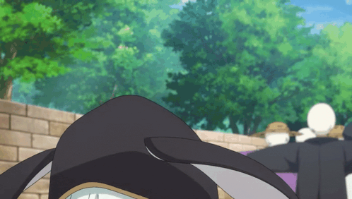 a group of people standing in front of a brick wall