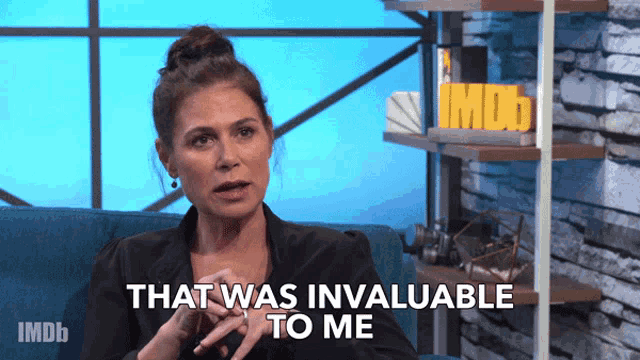 a woman says that was invaluable to me while sitting on a blue couch