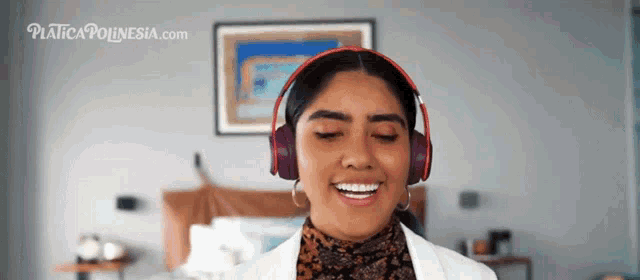 a woman wearing headphones is smiling in front of a placicapolynesia.com ad