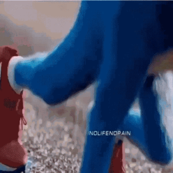 sonic the hedgehog is wearing a pair of red and blue shoes while running .