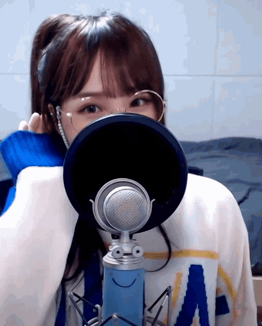 a girl wearing glasses and a sweater with the letter a on it