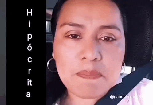 a close up of a woman 's face with the word hipocrita written on the bottom