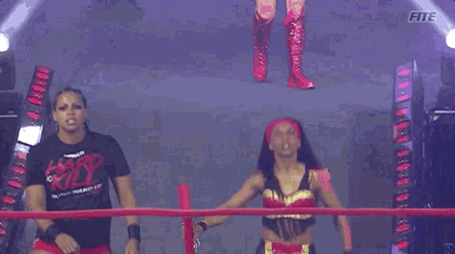 two women in a wrestling ring with one wearing a shirt that says fite