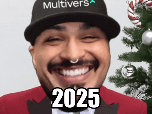 a man wearing a hat that says multivers on it smiles in front of a christmas tree