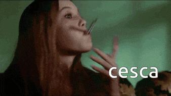 a woman is holding a toothpick in her mouth and the word cesca is on the bottom
