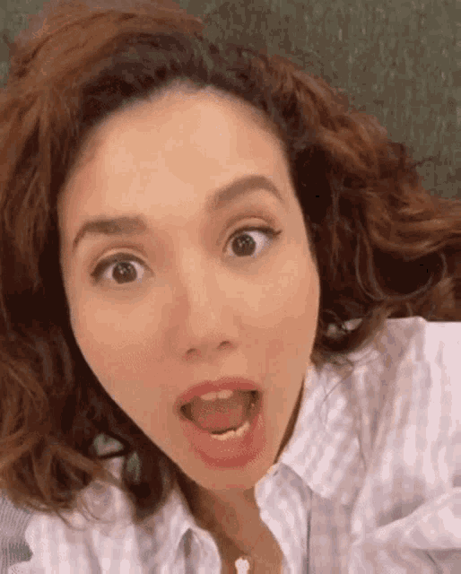 a close up of a woman making a funny face with her mouth open