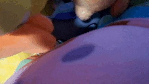 a close up of a person holding a black object