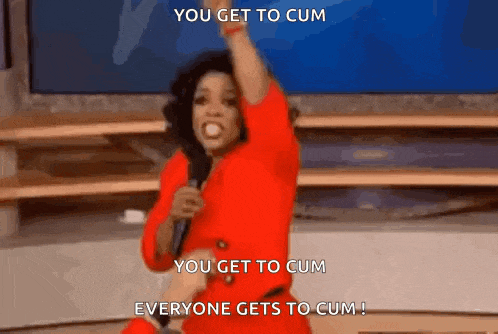 a woman in a red dress is holding a microphone and saying you get to cum you get to cum everyone gets to cum !