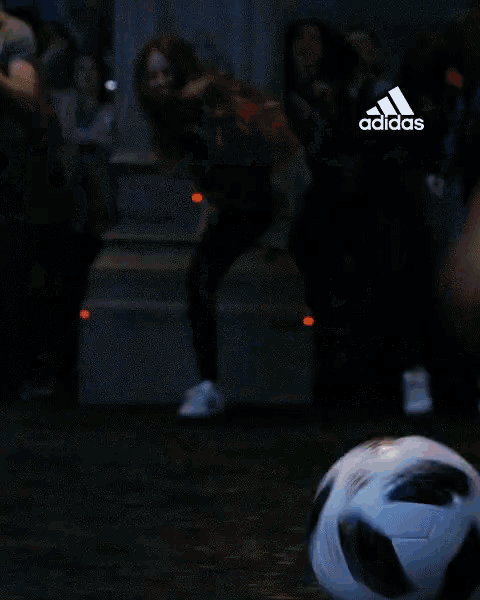 a person is kicking a soccer ball with the word godspeed in yellow