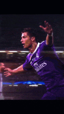 a close up of a soccer player wearing a blue jersey with the number 5 on it