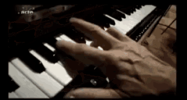 a close up of a person 's hand playing a piano .