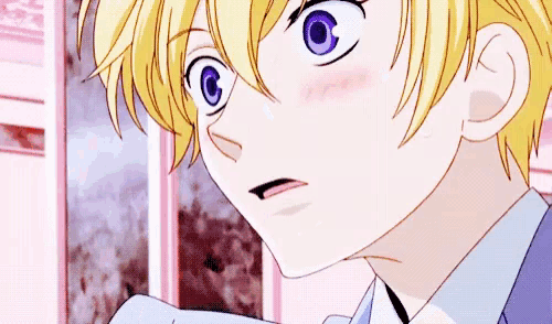 a close up of a person 's face with yellow hair and purple eyes .