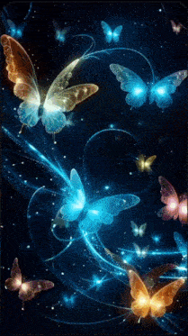 a group of butterflies are flying in the dark