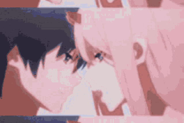 a boy and a girl are kissing each other on the forehead .