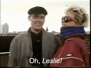 a man and a woman are standing next to each other and one of them is saying oh leslie
