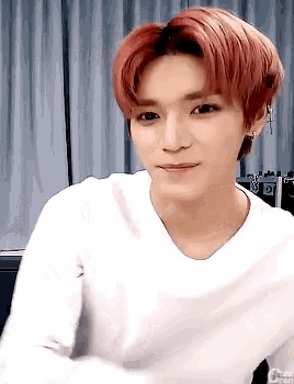a young man with red hair is wearing a white shirt with the word chen on it