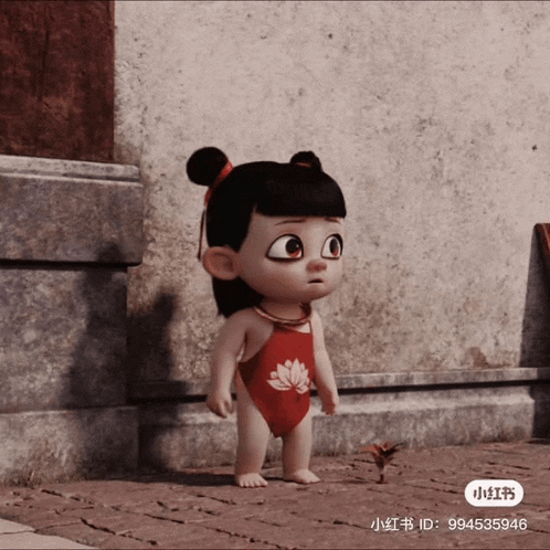 a little girl in a red swimsuit is standing on a sidewalk