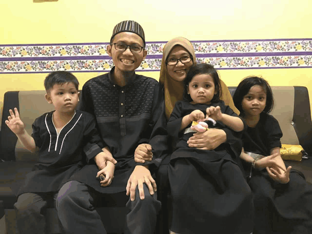 a family posing for a picture on a couch