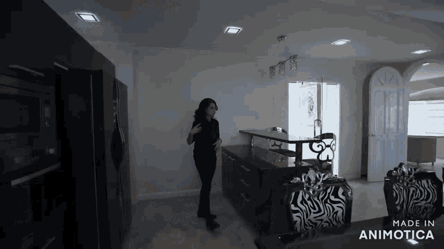 a woman is standing in a kitchen with the words made in animotica on the bottom