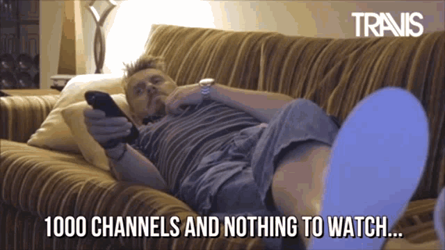 a man laying on a couch with the words 1000 channels and nothing to watch written below him